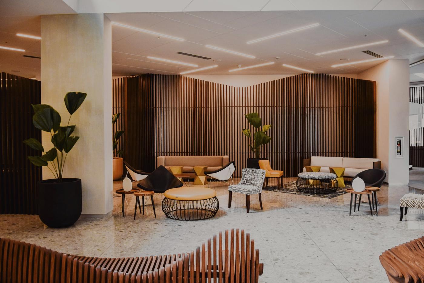 Hotel lobby with timber slat walls and lounge seating