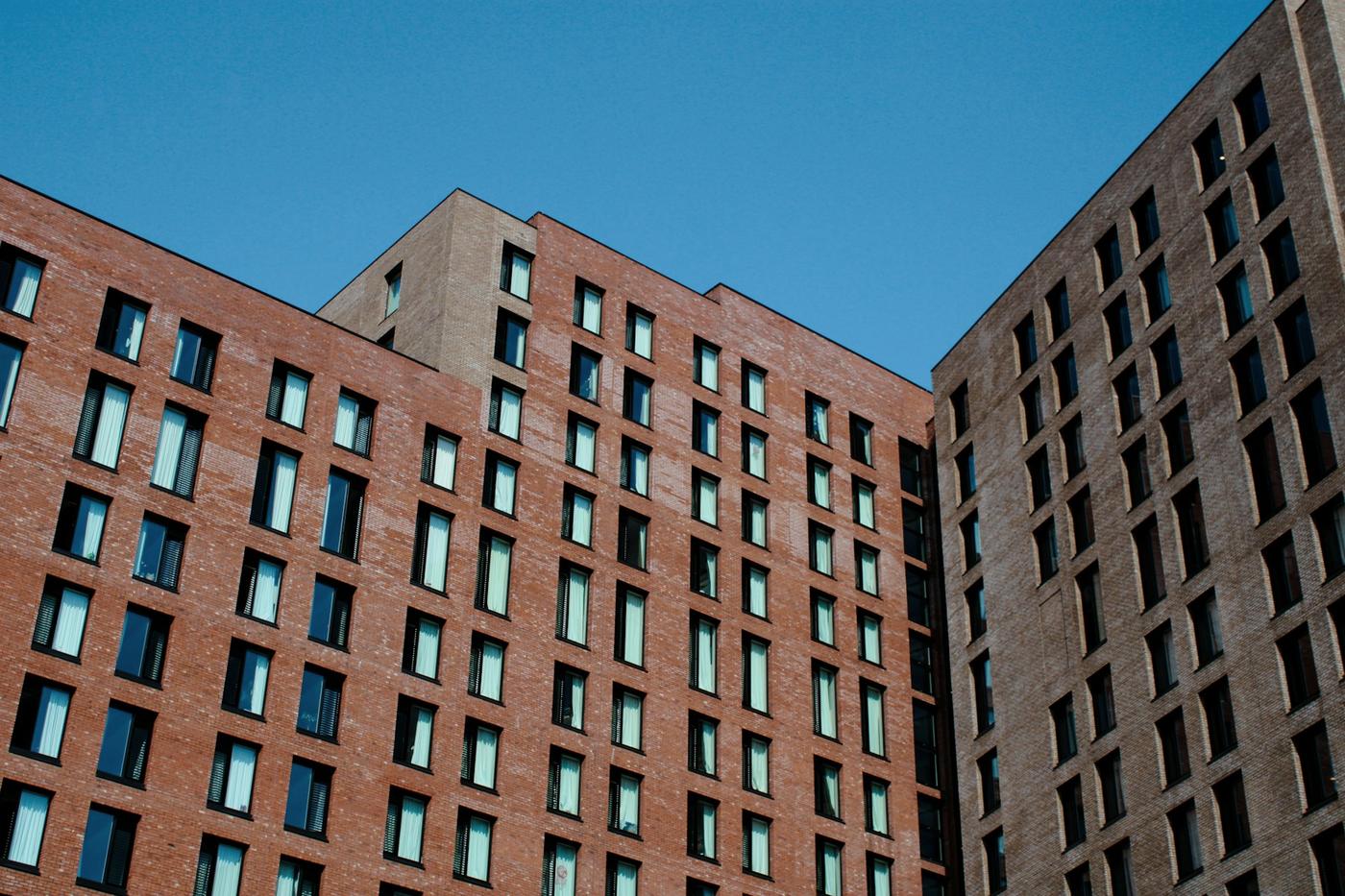 Brick student housing blocks against a blue sky