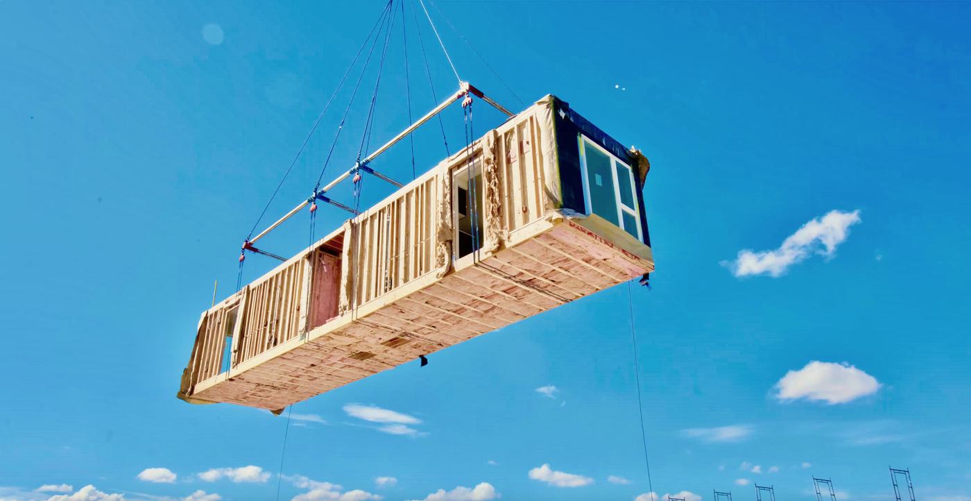 Wood-frame volumetric module flying on a crane spreader bar